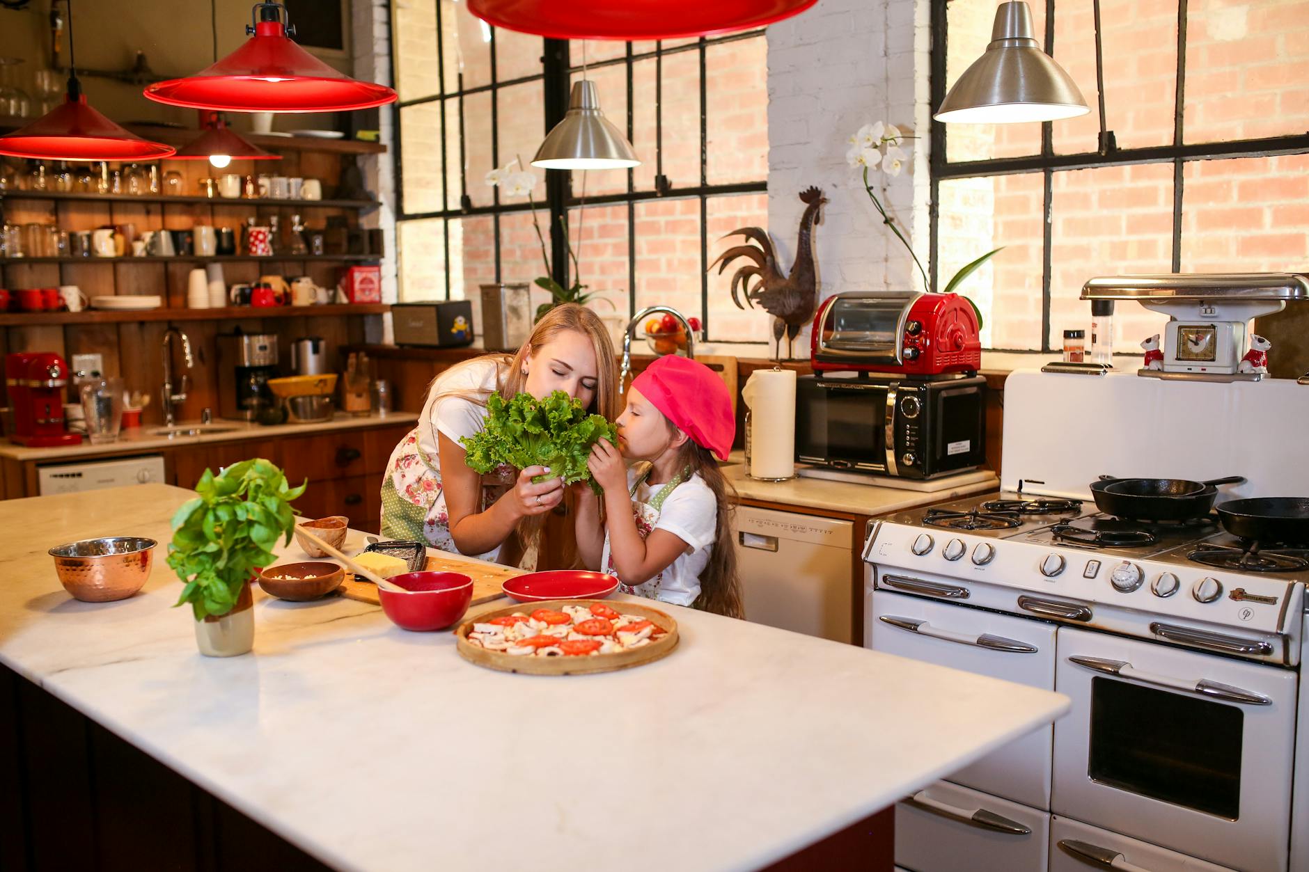Mama i córka gotują razem ziołowe potrawy w domowej kuchni